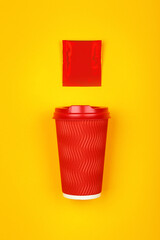 Red paper coffee cup over yellow