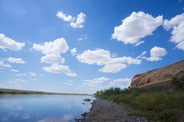 Fototapeta na wymiar Beautiful clouds in the river valley. Beautiful blue sky with white clouds. landscape