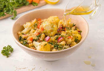 Vegetarian salad with quinoa and cauliflower on a light background
