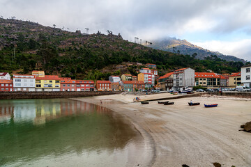 Fototapeta na wymiar View of the beach and colorful village of O Pindo in Galicia, northwestern Spain.