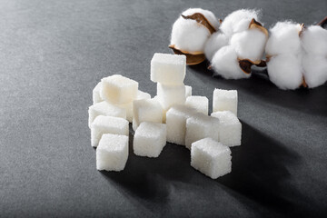 Refined sugar on a black background. Pyramid of sugar.