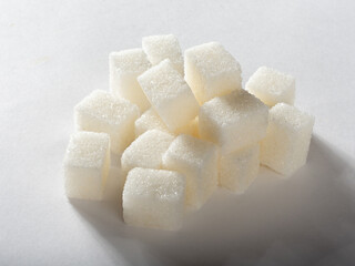 Refined sugar on a white background. Pyramid of sugar.