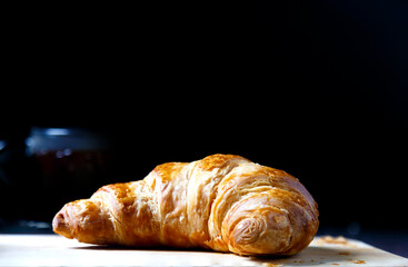
French butter croissant, placed on wood