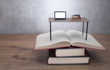 Study desk with laptop and books