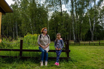 Fototapeta na wymiar beautiful girl and her grandmother are going to the forest for an excursion