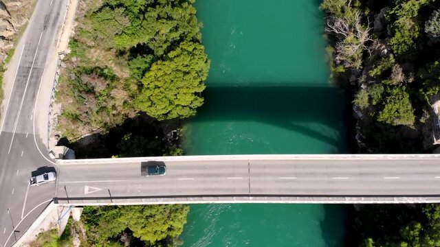 Bridge across Clutha river on New Zealand countryside. Aerial tilt up reveal shot from Roxburgh, Central Otago.