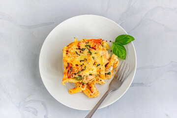 Baked Chicken Pasta, Traditional Italian Food, Slice of Baked Pasta on a Plate Top Down Photo

