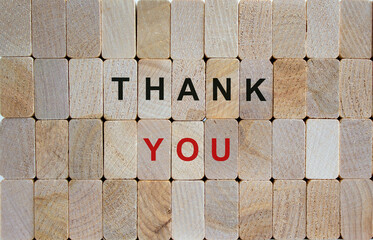 Wooden blocks form the words 'thank you'. Beautiful wooden background. Business concept.