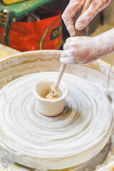 Children making pottery during ceramic lesson with clay