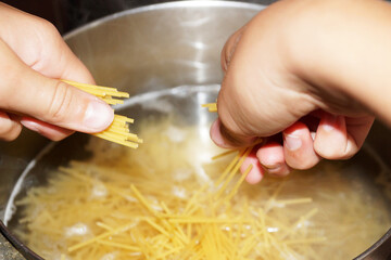 cooking spaghetti in a saucepan close up