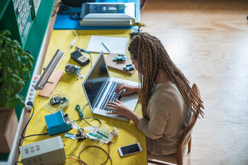 Unrecognizable woman at home using laptop computer stock photo