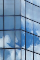 Clouds reflected in the glass facade of a skyscraper