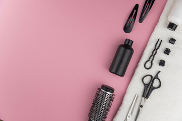 Professional hair dresser tools with copy space. Hair stylist equipment set on pink background....