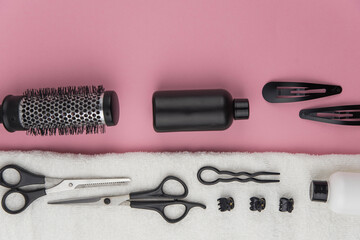 Professional hair dresser tools with copy space. Hair stylist equipment set on pink background....