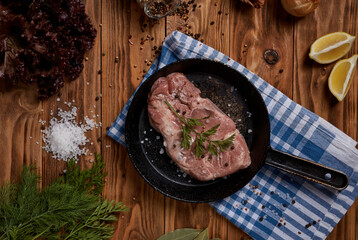 Pork steak in a frying pan, grilled meat, recipe design for cooking