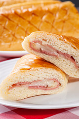 .Baked Brazilian appetizer stuffed with ham and cheese.