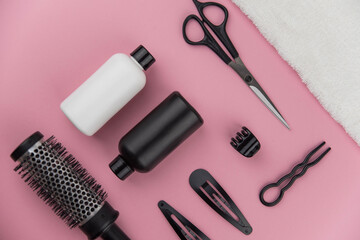 Professional hair dresser tools with copy space. Hair stylist equipment set on pink background....