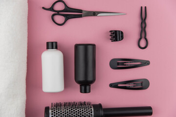 Professional hair dresser tools with copy space. Hair stylist equipment set on pink background....