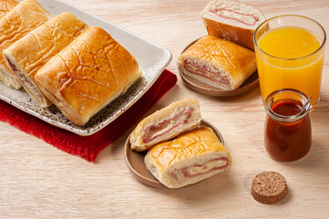 .Baked Brazilian appetizer stuffed with ham and cheese.