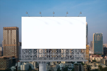 Obraz premium Blank white road billboard with Bangkok cityscape background at sunset. Street advertising poster, mock up, 3D rendering. Front view. The concept of marketing communication to promote or sell idea.