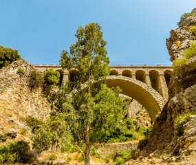 A view across the railway bridge close to the entrance to the Gaitanejo river gorge near Ardales, Spain in the summertime