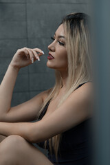 Fototapeta premium close up of a woman sitting inside a room with stone walls
