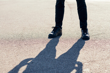 runner legs with sport shoes on the asphalt