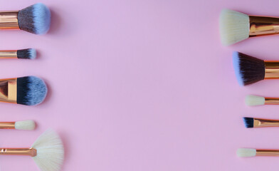 premium makeup brushes on pink background, creative cosmetics flat lay, tools for make up, copy space