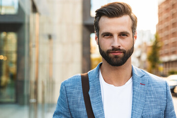 Attractive young bearded man walking outdoors - Powered by Adobe