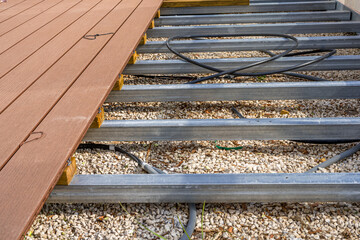  Construction of a wooden terrace on a balcony. A new wooden, timber deck being constructed. City background. 