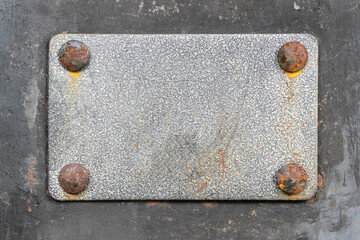 Blank metal plaque with rusty screws. Place for text.