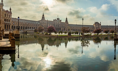 Fototapeta premium An early morning view across the elaborately decorated Plaza de Espana in Seville, Spain in summertime