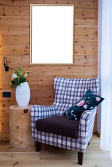 frame on wooden wall in interior with chair, mock up