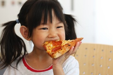 Little girl eating pizza 