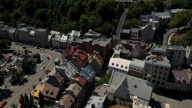 Cars Travelling On The Asphalt Road By The Lower Town Of Old Quebec Near The Historic Hotel Of Fairmont Le Chateau Frontenac - Chateau Frontenac In Quebec City, Canada.  -aerial drone
