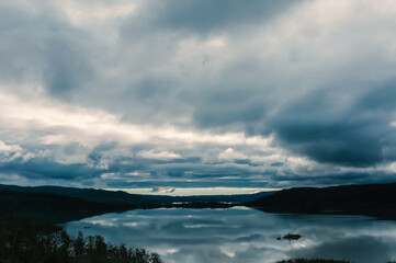 Fototapeta premium Low lead clouds over a lake in Norway