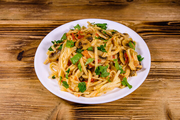 Pasta with mushrooms and tomato sauce in a plate