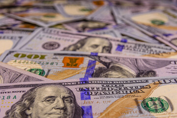 Background of one hundred dollar banknotes. Selective focus