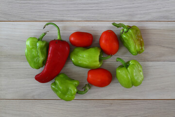 green pepper, tomato, red pepper on a brown wooden background top view, fresh vegetables,