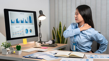 Fototapeta na wymiar Young Asian Business woman stretching herself and relax while working hard