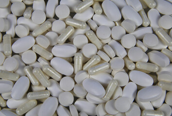 Fototapeta na wymiar Full frame closeup of pile countless white pills and capsules
