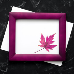 Blank paper, maple leaf, and wood frame mockup toned purple. Modern minimal composition. Invitation or greeting cards.Top view, flat lay, copy space.