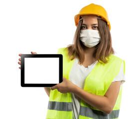 Amused young woman in yellow hardhat, green reflective vest and lumberjack shirt