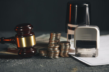 Miniature house with money and tax papers.