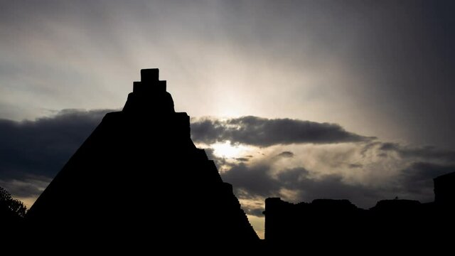 Maya Pyramid in Uxmal, Time Lapse at Sunrise with Fast Clouds and Dark Silhouette of Ancient Temple, Mexico