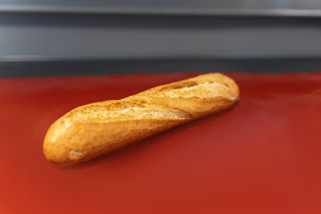 French baguette lies on the red table
