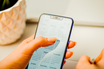 Phone calendar. Planning your day concept. Woman using mobile