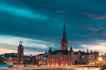 Stockholm, Sweden. Scenic View Of Stockholm Skyline At Summer Evening Night. Famous Popular Destination Scenic Place Under Dramatic Sky In Night Lights. Riddarholm Church, City Hall, Subway Railway