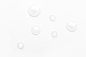 drops of water on a white background, top view