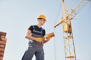Construction worker in uniform and safety equipment have job on building